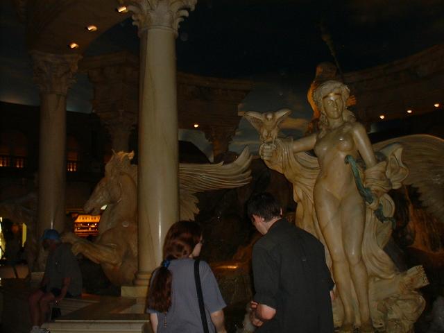 Elle and IB throw coins and make wishes at a Caesar's Palace Fountain
